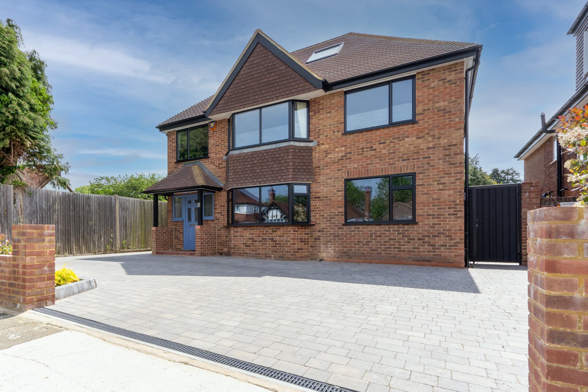 A completed home with a new block-paved driveway